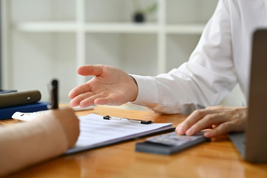 Cropped image of male bank manager broker or financial advisor consulting a client at office.